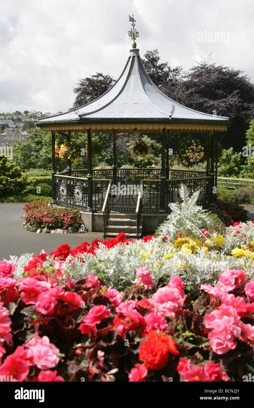 City of Truro, England. Flower beds in full bloom in Truro’s Victoria Gardens, with the Victorian bandstand in the background. Stock Photo