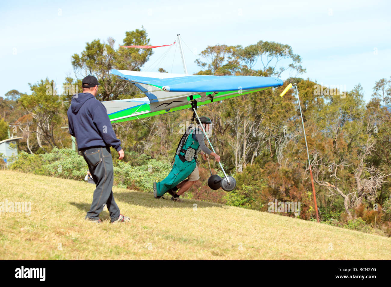 Pilot runs to get lift for his hang glider Stock Photo