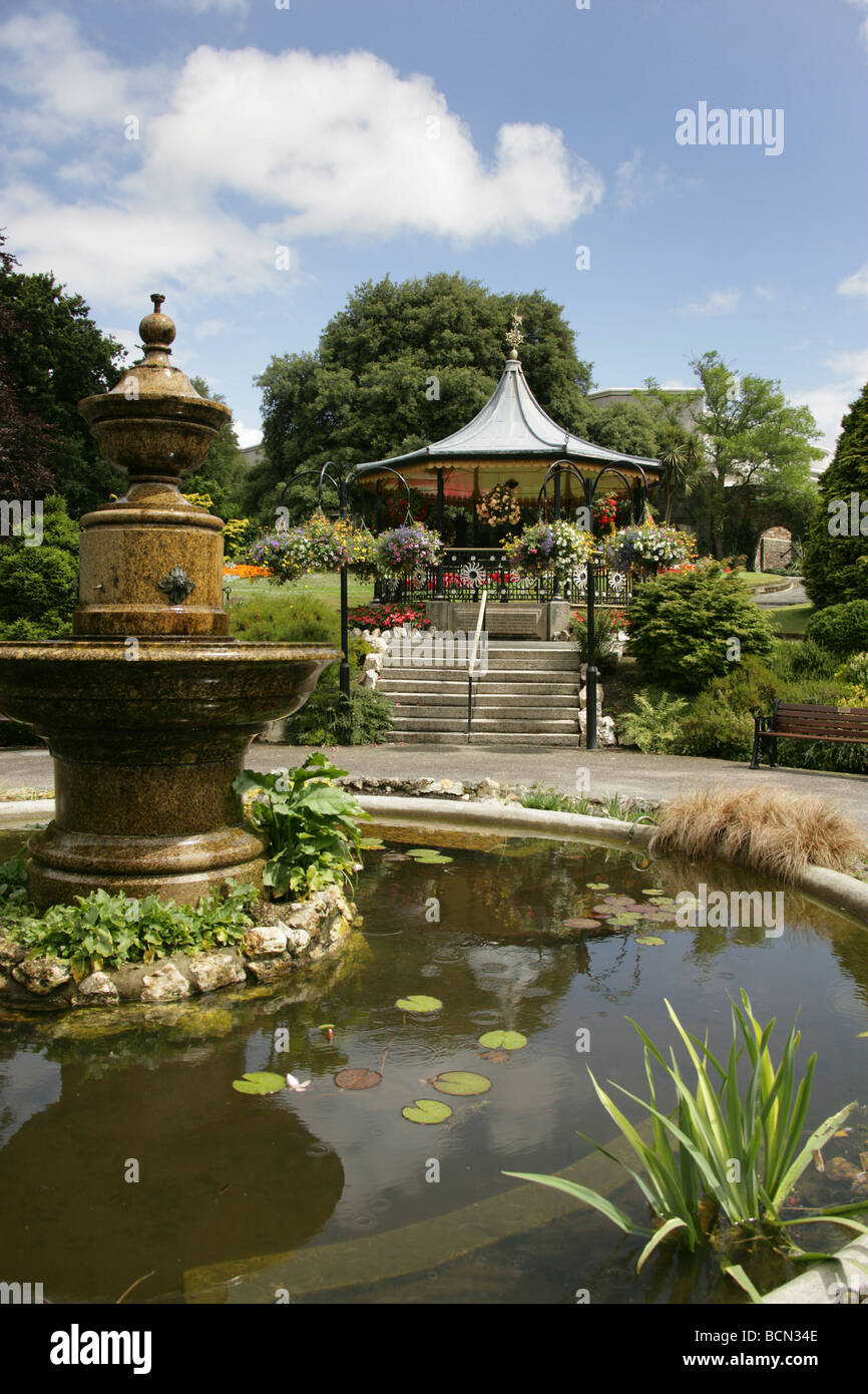 City of Truro, England. Ornate fountain in Truro’s Victoria Gardens, with the Victorian bandstand in the background. Stock Photo