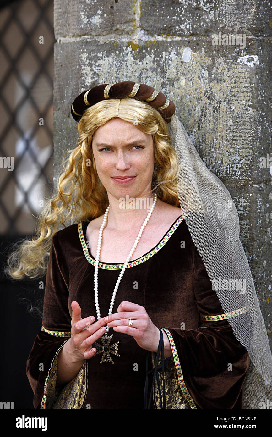 Blonde woman dressed in medieval dress during a period clothing weekend ...