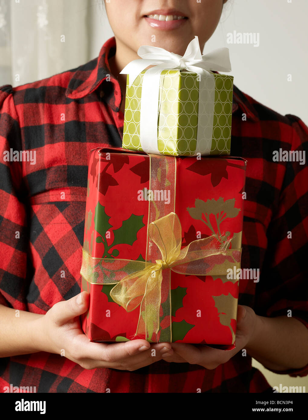 Woman Holding Two Christmas Presents Stock Photo