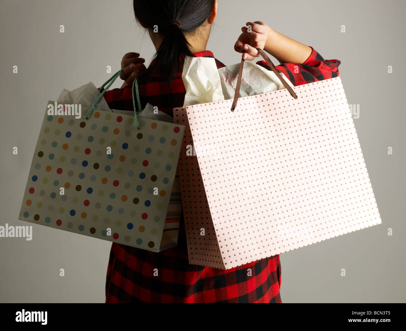 Rear View of Woman with Shopping Bags Stock Photo