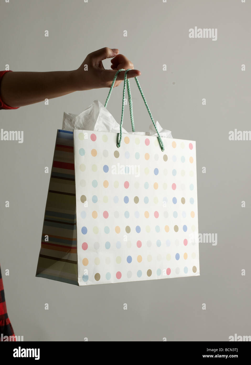 Shopping Bag Hanging From Finger Stock Photo
