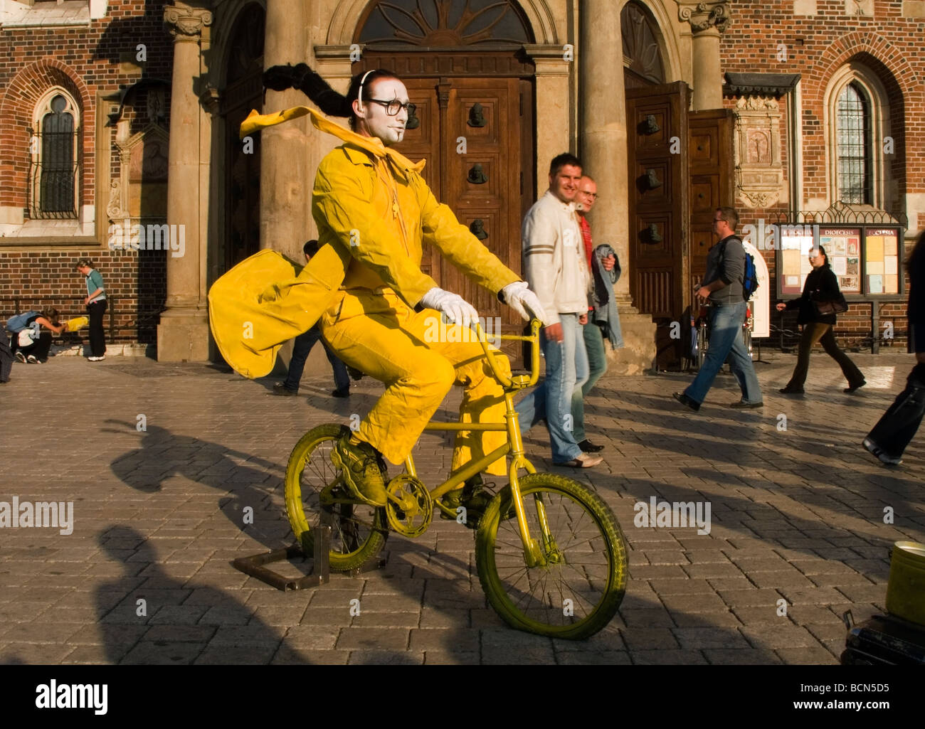 Funny street performer on bicycle at Main Market Square Krakow Poland Stock Photo