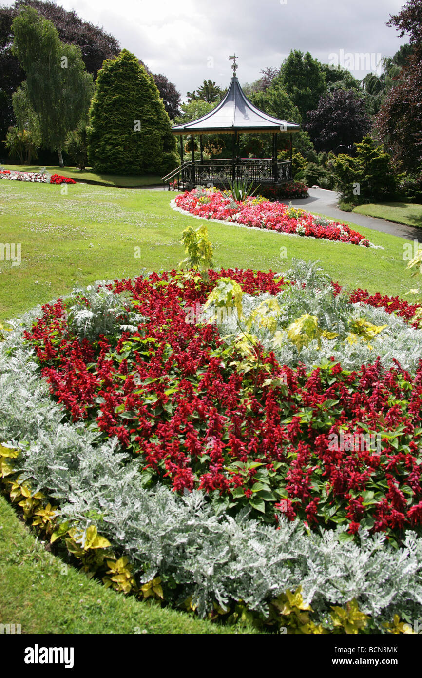 City of Truro, England. Flower beds in full bloom in Truro’s Victoria Gardens, with the Victorian bandstand in the background. Stock Photo