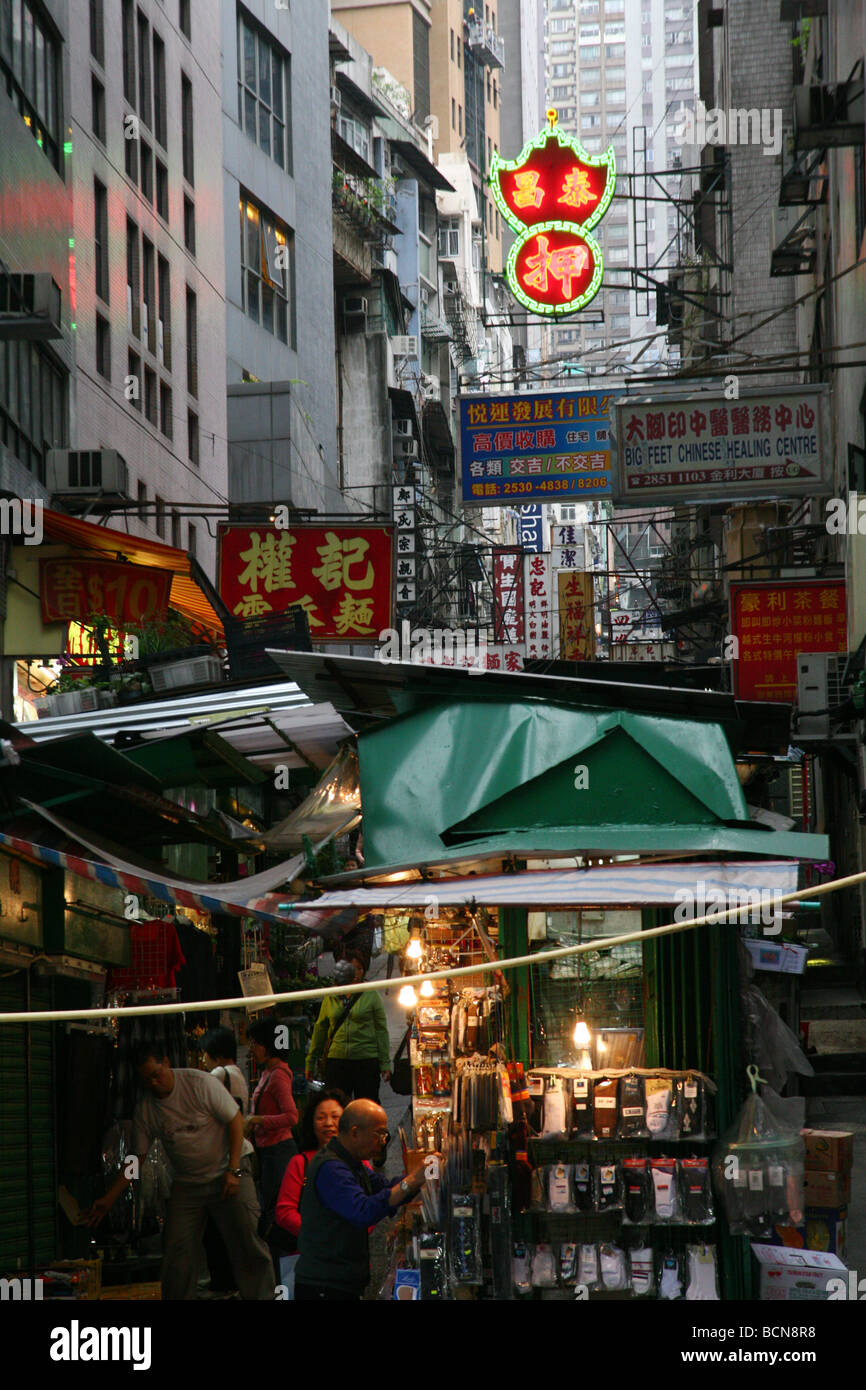 Crowded shops and neon lights in the narrow Ladder Street, Hong Kong ...