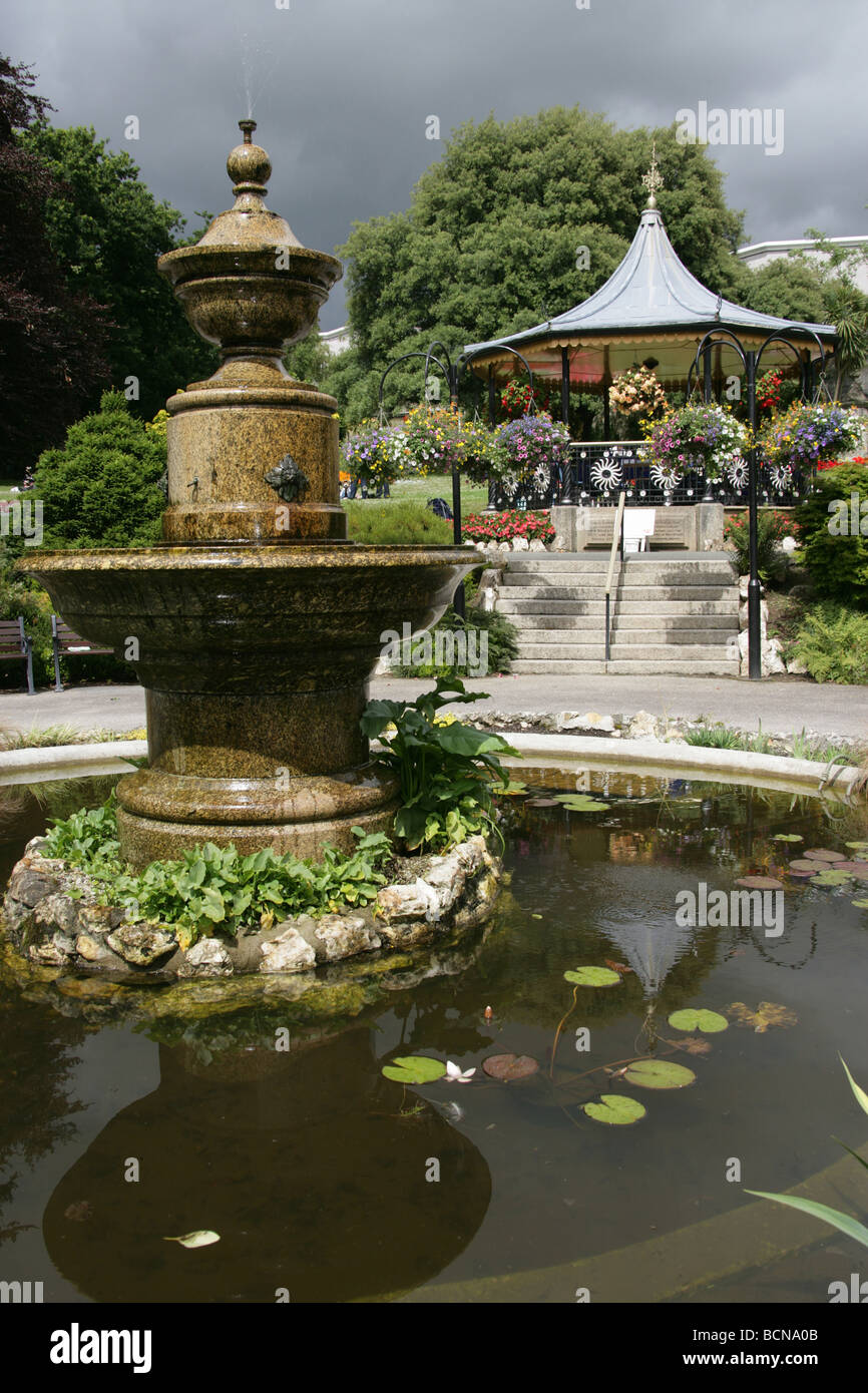 City of Truro, England. Ornate fountain in Truro’s Victoria Gardens, with the Victorian bandstand in the background. Stock Photo