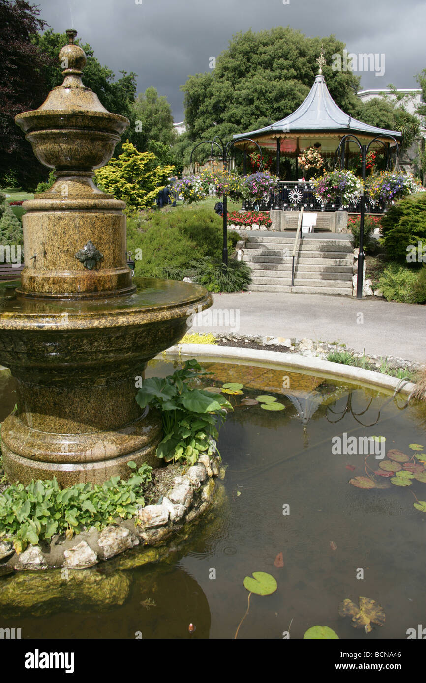City of Truro, England. Ornate fountain in Truro’s Victoria Gardens, with the Victorian bandstand in the background. Stock Photo