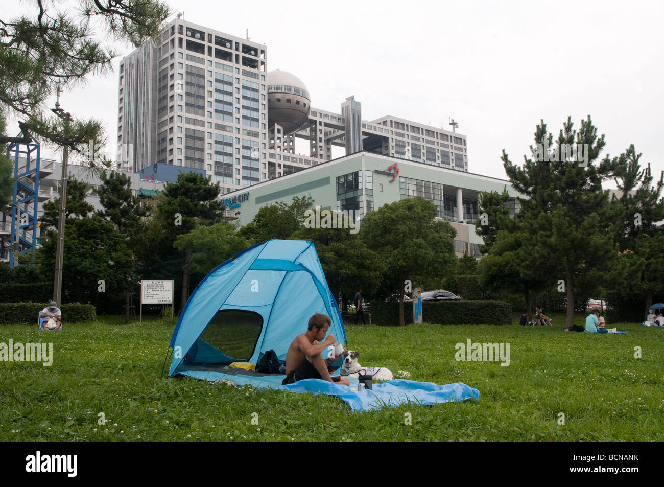 Man with his dog camping in the large artificial Odaiba island in Tokyo Bay, Japan Stock Photo