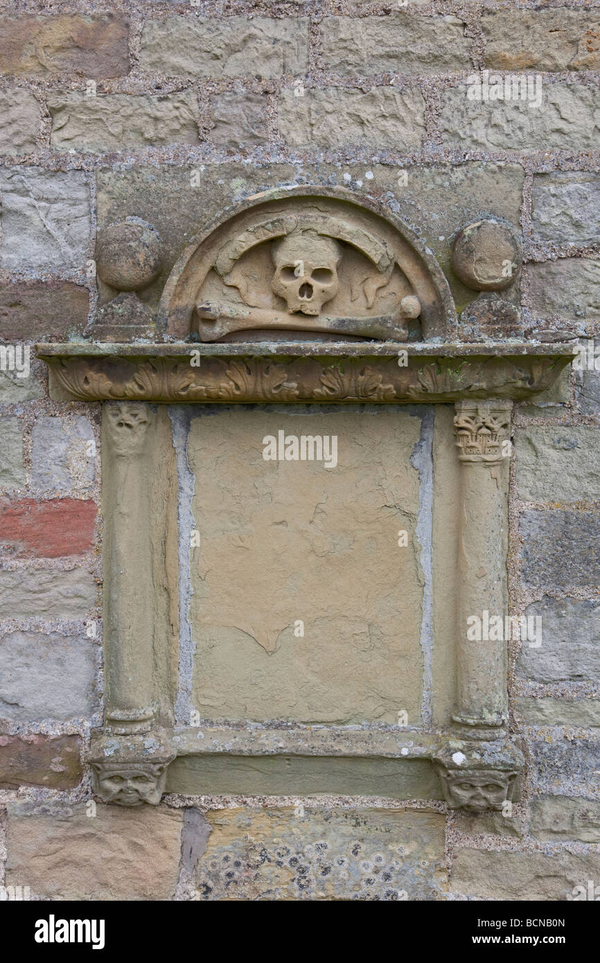Skull and bone carving on old gravestone Stock Photo Alamy