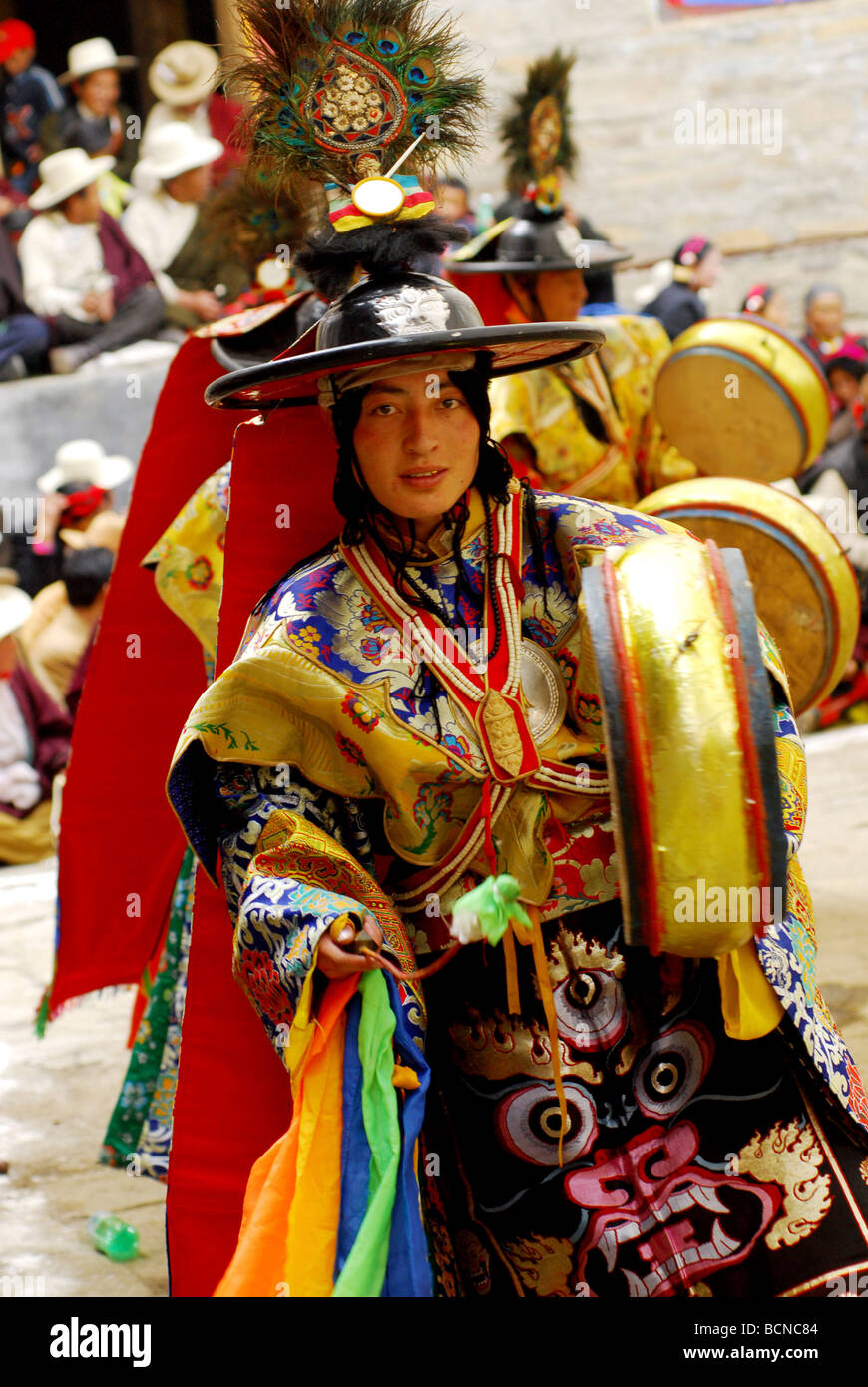 Lamas in elaborate costume performing religious ritual dance during ...