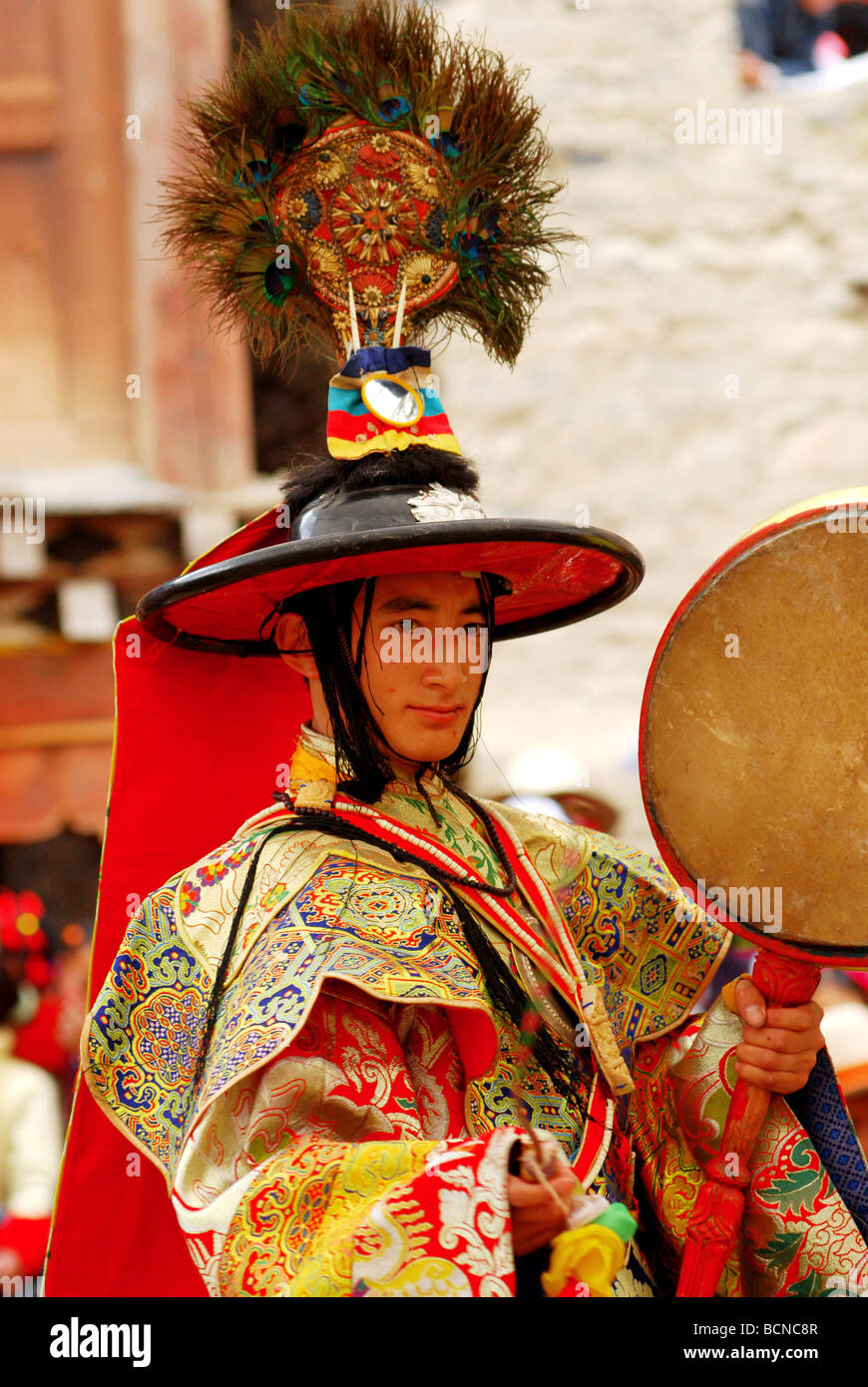 Lama in elaborate costume performing religious ritual dance during Cham ...