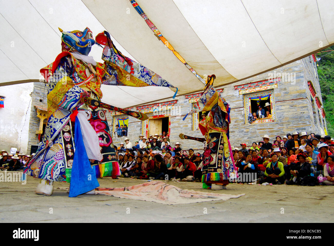 Lamas in elaborate costume and mask performing religious ritual dance ...