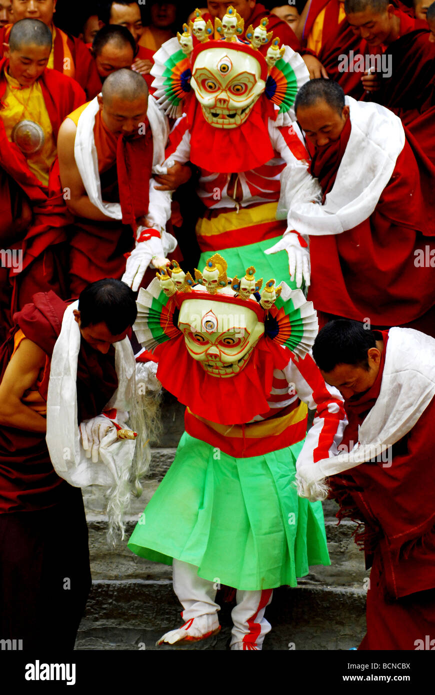 Lamas in costume and mask performing religious ritual dance during Cham ...