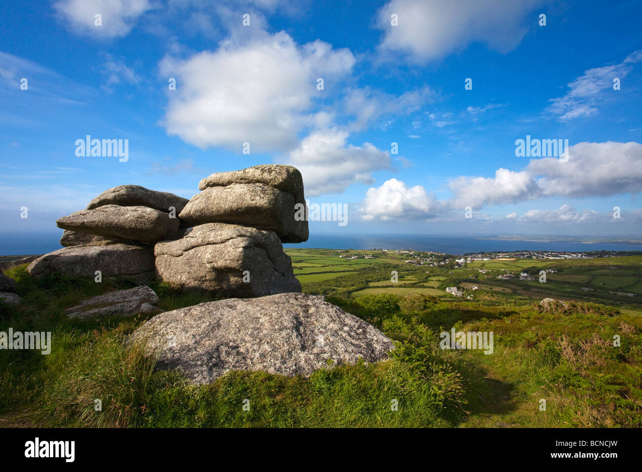 Granite tor of Trendrine Hill in summer sunshine looking towards St Ives West Penwith Cornwall England UK United Kingdom GB Stock Photo