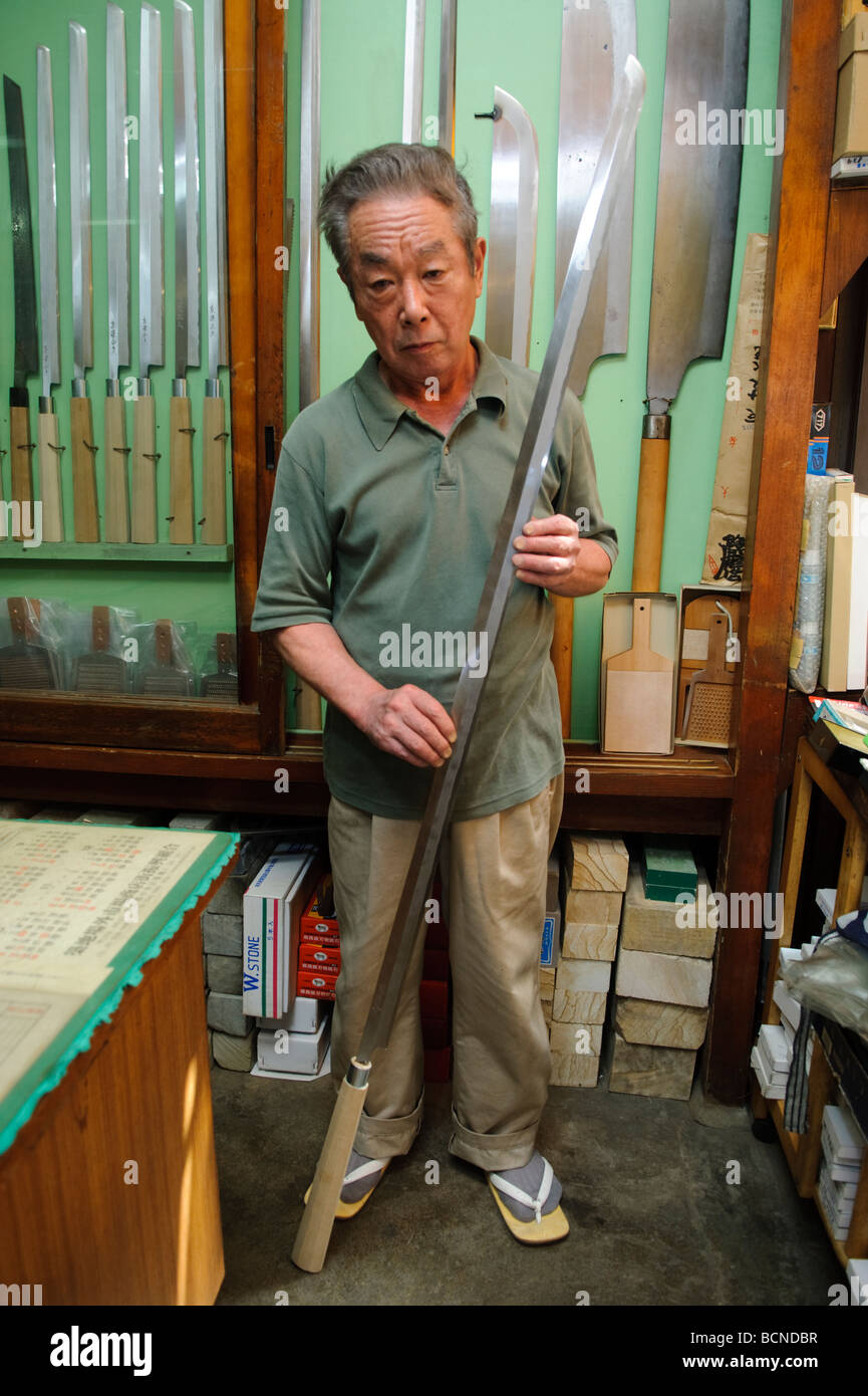 Shop owner holds a tuna knife, Azuma Knife Shop Tsukiji fish market