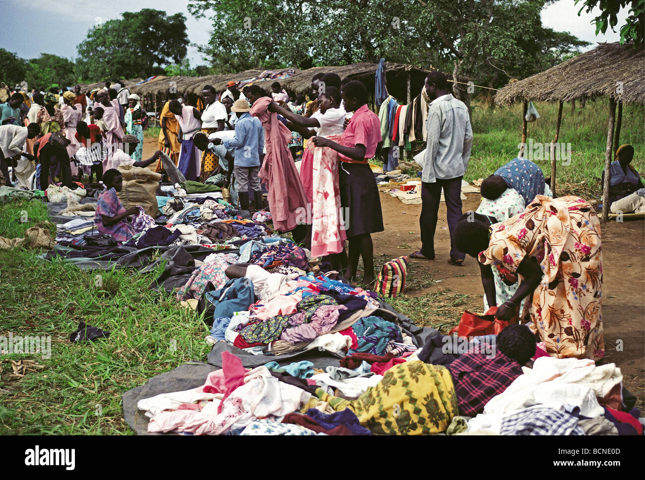 African women and men at choosing clothes at second hand market Port Masindi Uganda East Africa Stock Photo