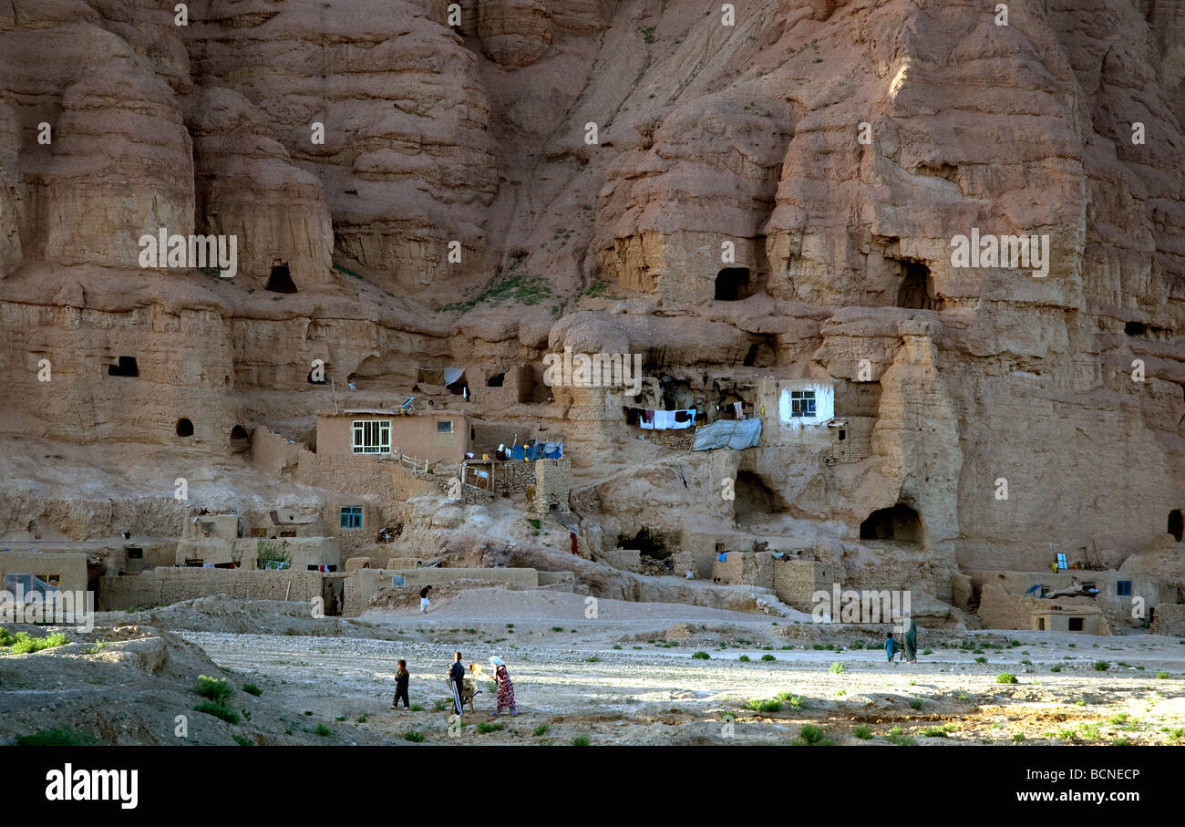 West of the great Buddha niches in Afghanistan's Bamiyan, caves in the sandstone cliffs are home to poor families and refugees Stock Photo