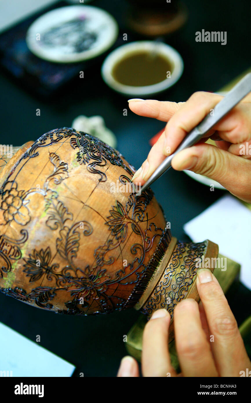 The cloisonné wire is glued to the enamel surface with gum tragacanth, Beijing, China Stock Photo