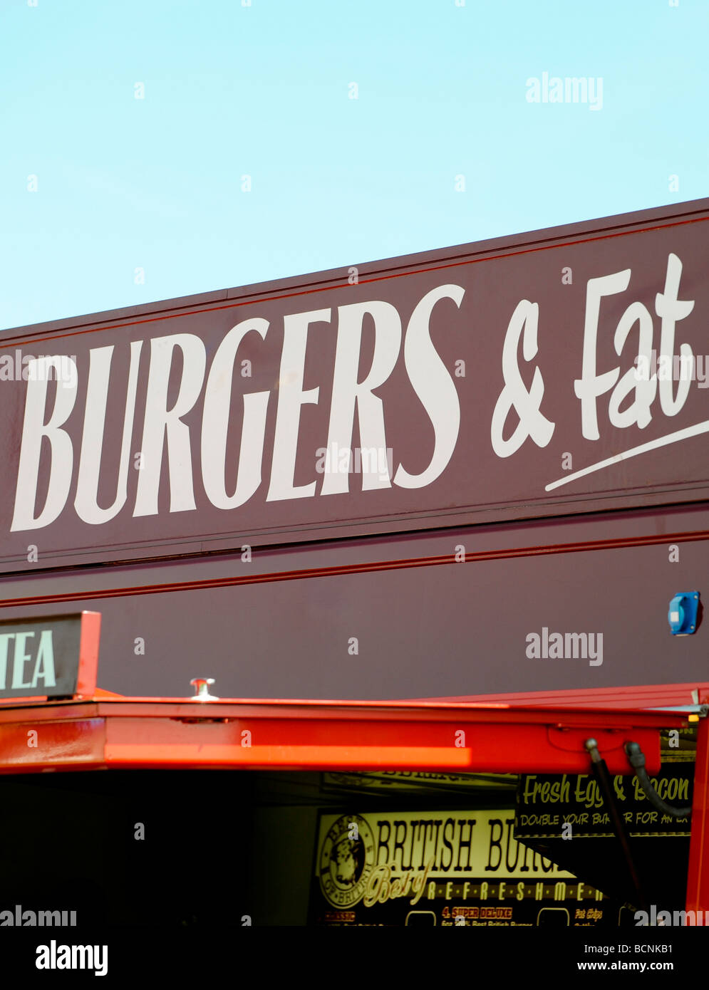 Fatty food: Part of a burger van sign reads 'burgers and fat' at a summer event in the UK. Picture Jim Holden. Stock Photo