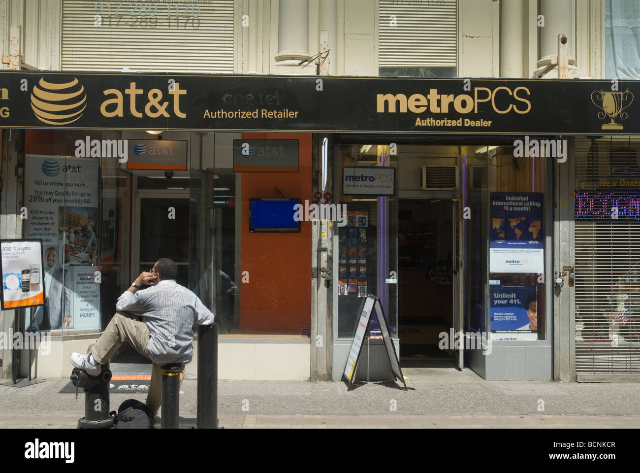 An AT T Wireless store competing with a Metro PCS store in New York Stock Photo