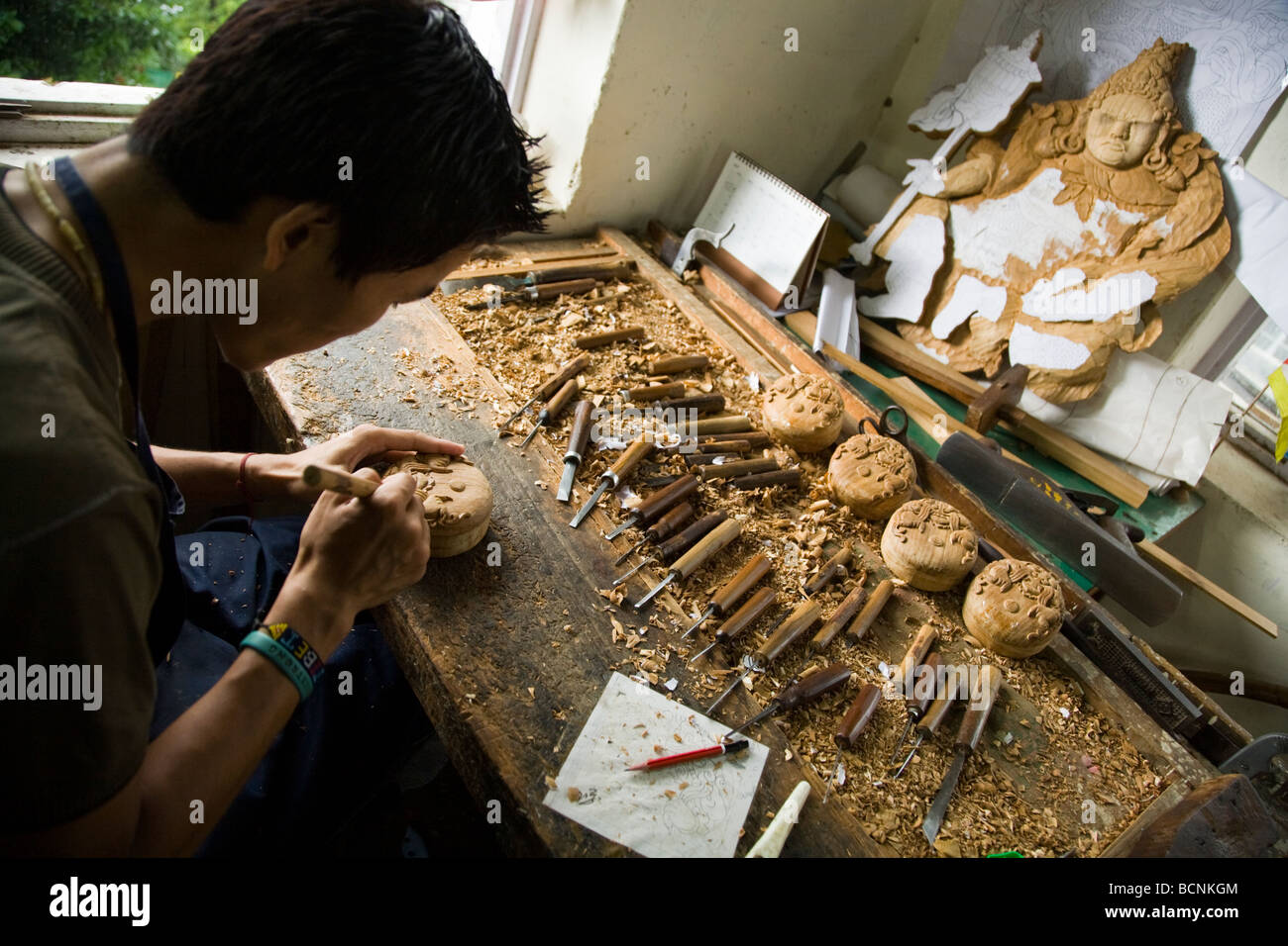 Tibetan refugee working in the woodworking workshop at the Norbulingka Institute. Sidhpur, Dharamsala. Himachal Pradesh. India. Stock Photo