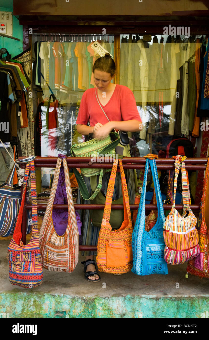 Western woman tourist choosing a bag in a McLeod Ganj shop. Dharamsala. Himachal Pradesh. India. Stock Photo