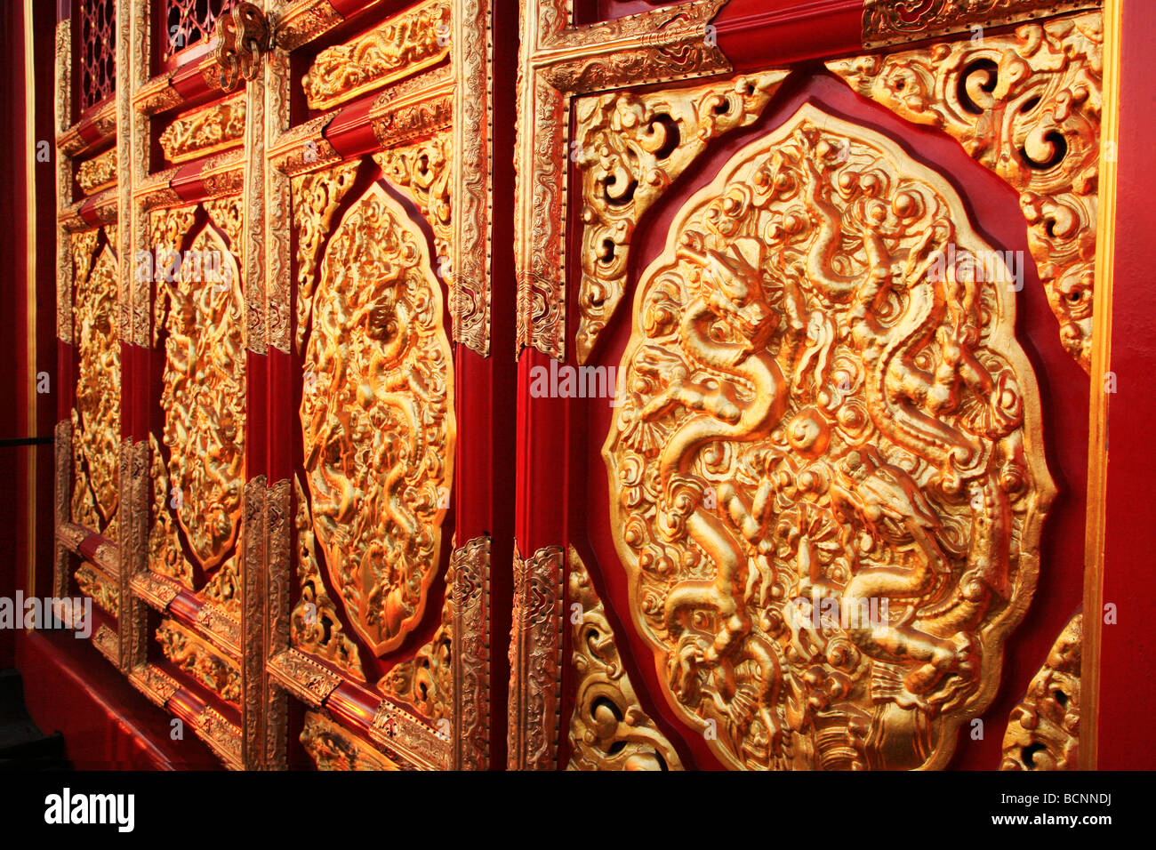 Elaborate door panels covered with gold leaf in dragon and cloud ...