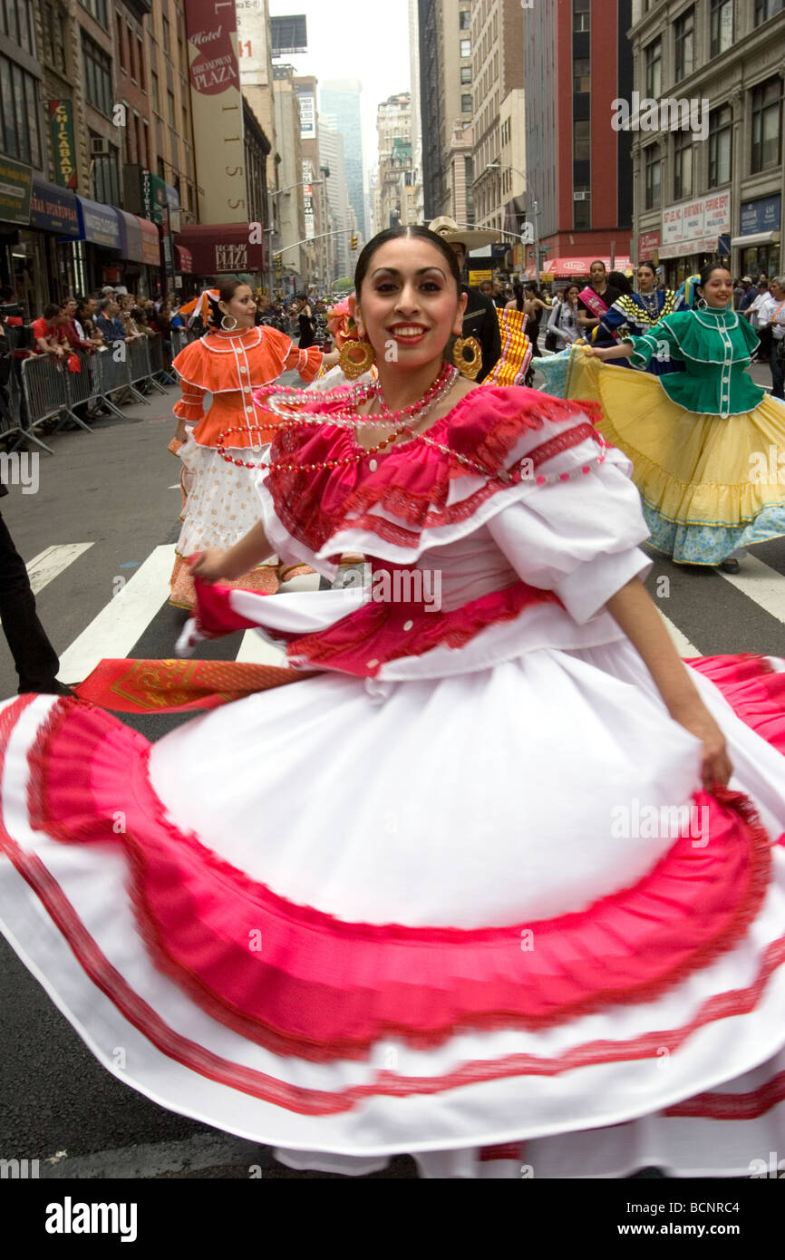 Ecuadorian woman dances down Broadway in NYC at the annual New York