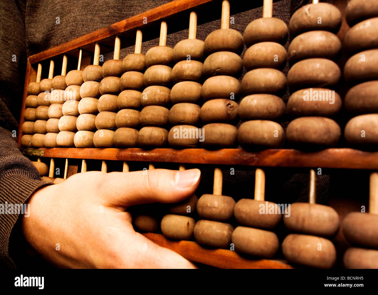Hand holding Chinese traditional calculator abacus Stock Photo Alamy