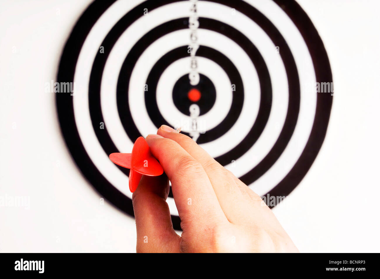 Hand throwing dart toward target Stock Photo Alamy