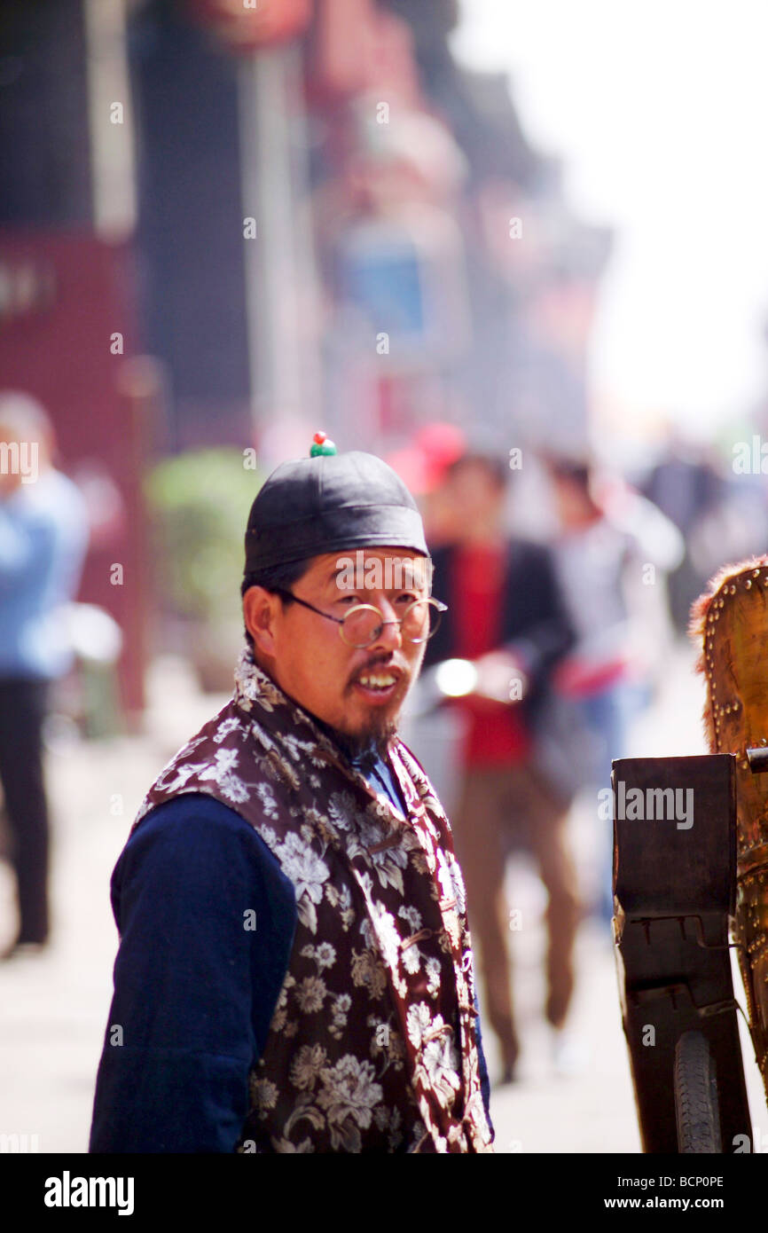 Smiling rickshaw driver in traditional Chinese costume waiting for ...