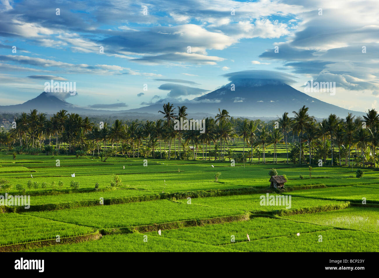 storm clouds clearing over the volcanic peak of Gunnung Anung and the rice fields, near Ubud at dawn, Bali, Indonesia Stock Photo