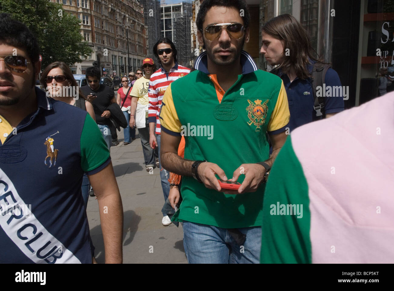 Middle Eastern tourists in Knightsbridge London. Young men wearing Ralph  Lauren designer Polo Shirts HOMER SYKES Stock Photo - Alamy