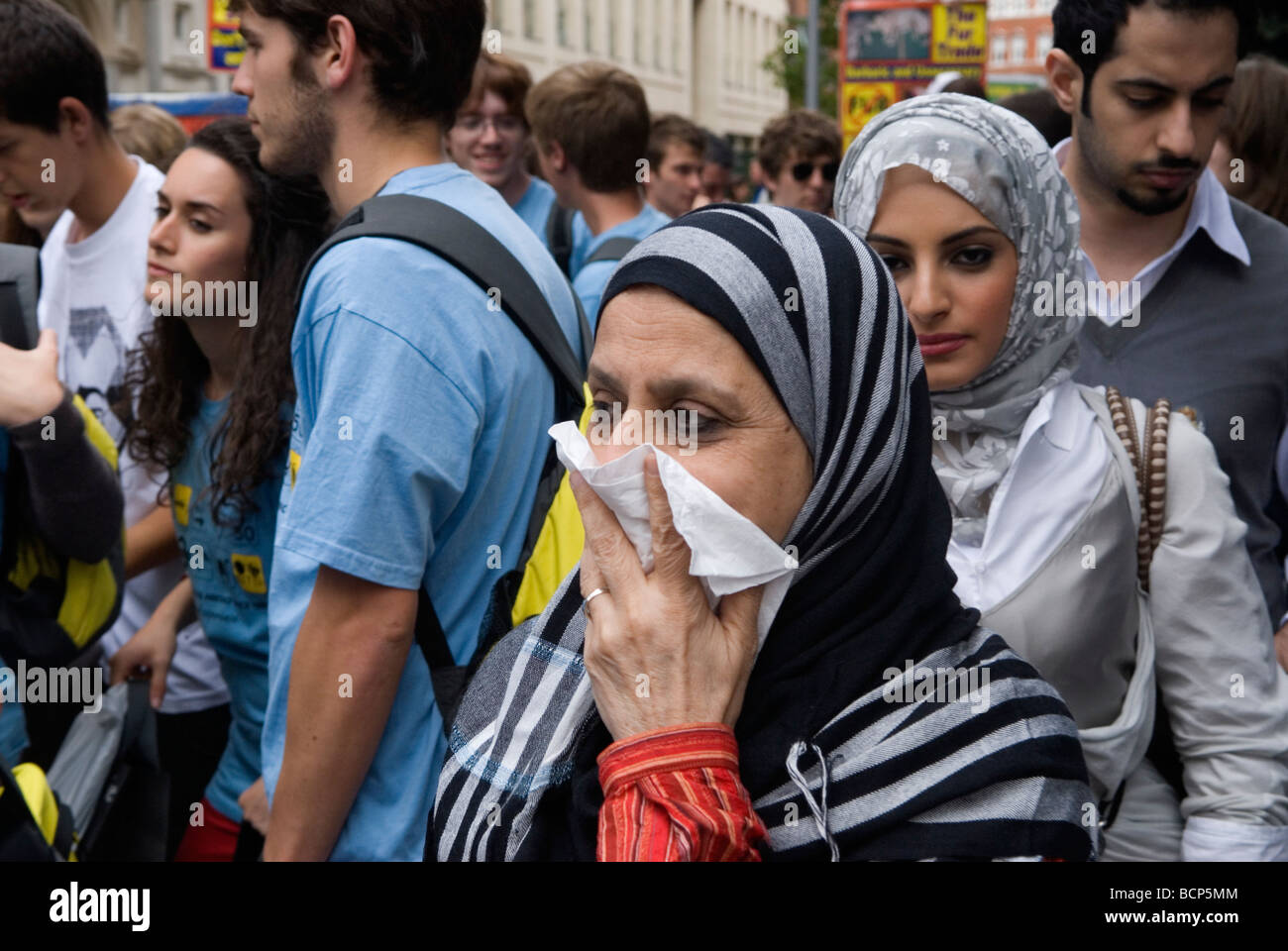 Middle Eastern tourists in Knightsbridge woman holding a handkerchief up against her nose and mouth, afraid of germs London 2009 2000s UK  HOMER SYKES Stock Photo