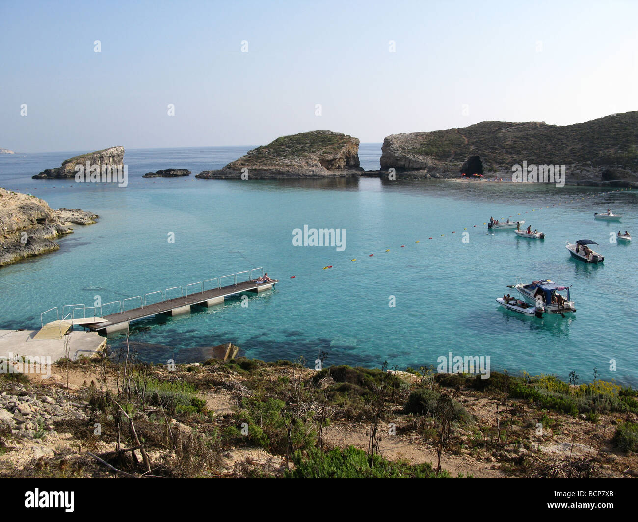 Pleasure boats and yachts in the Blue Lagoon with Cominotto beyond
