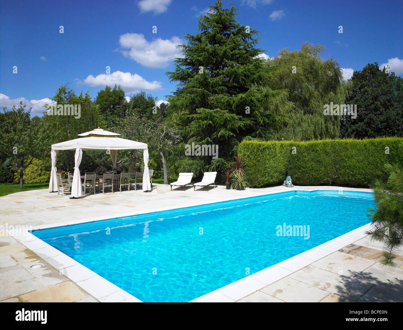 Outside swimming pool, with shaded seating area Stock Photo Alamy