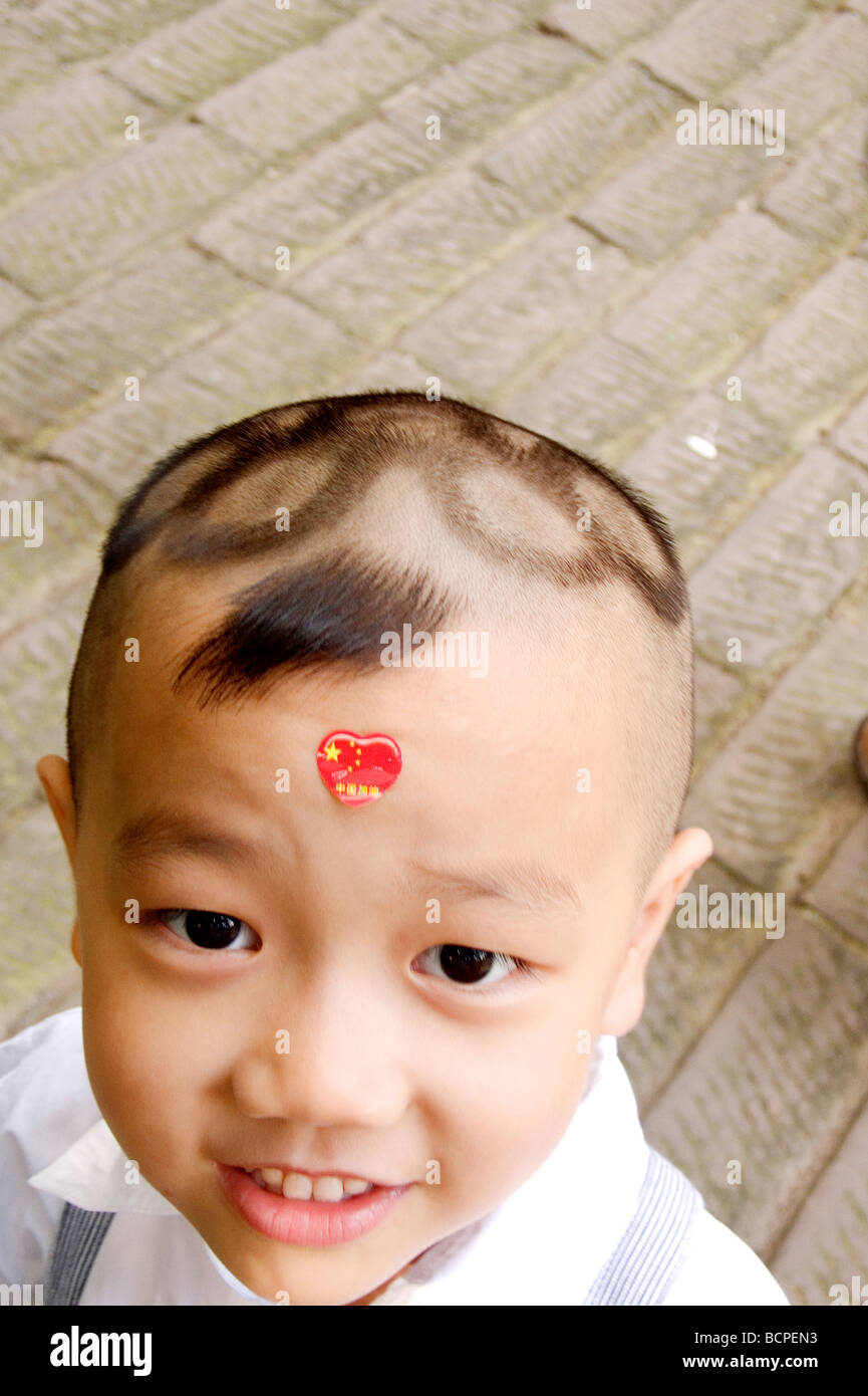 Chinese boy with Olympic logo hair cut smiling at camera, Beijing, China  Stock Photo - Alamy