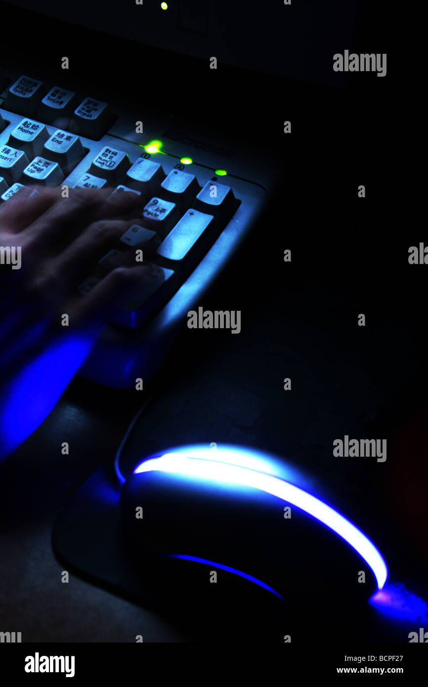Hand and illuminating keyborad & mouse Stock Photo