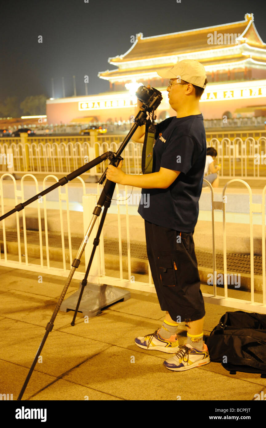 Chinese man taking photo in Tian An Men Square, Beijing, China Stock Photo