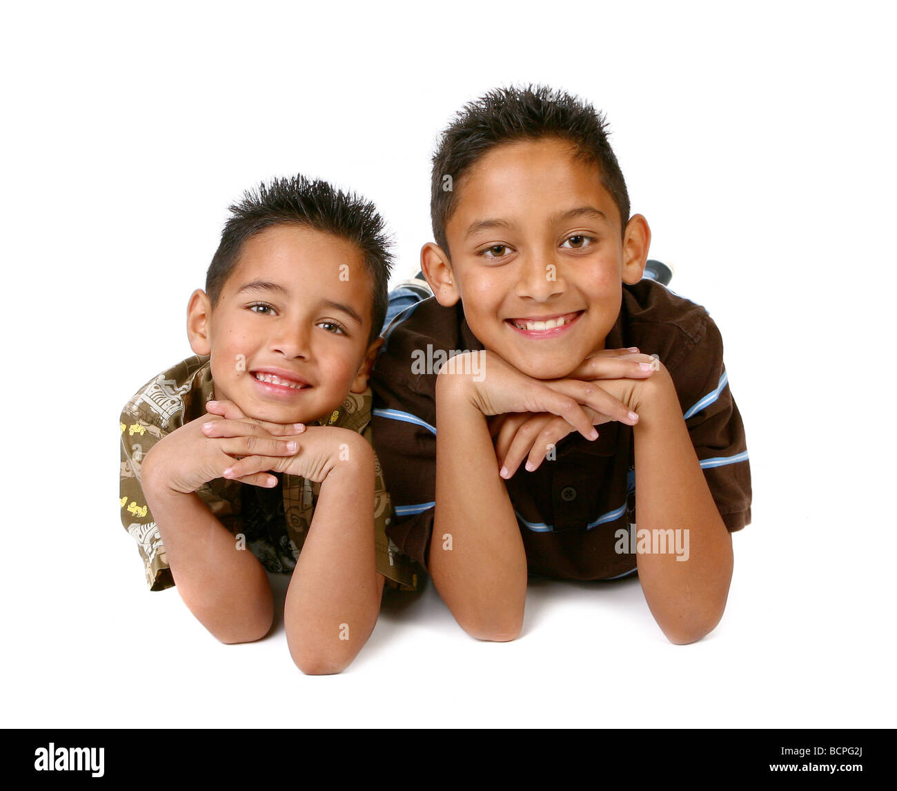 Hispanic Young Brothers Smiling on White Background Stock Photo