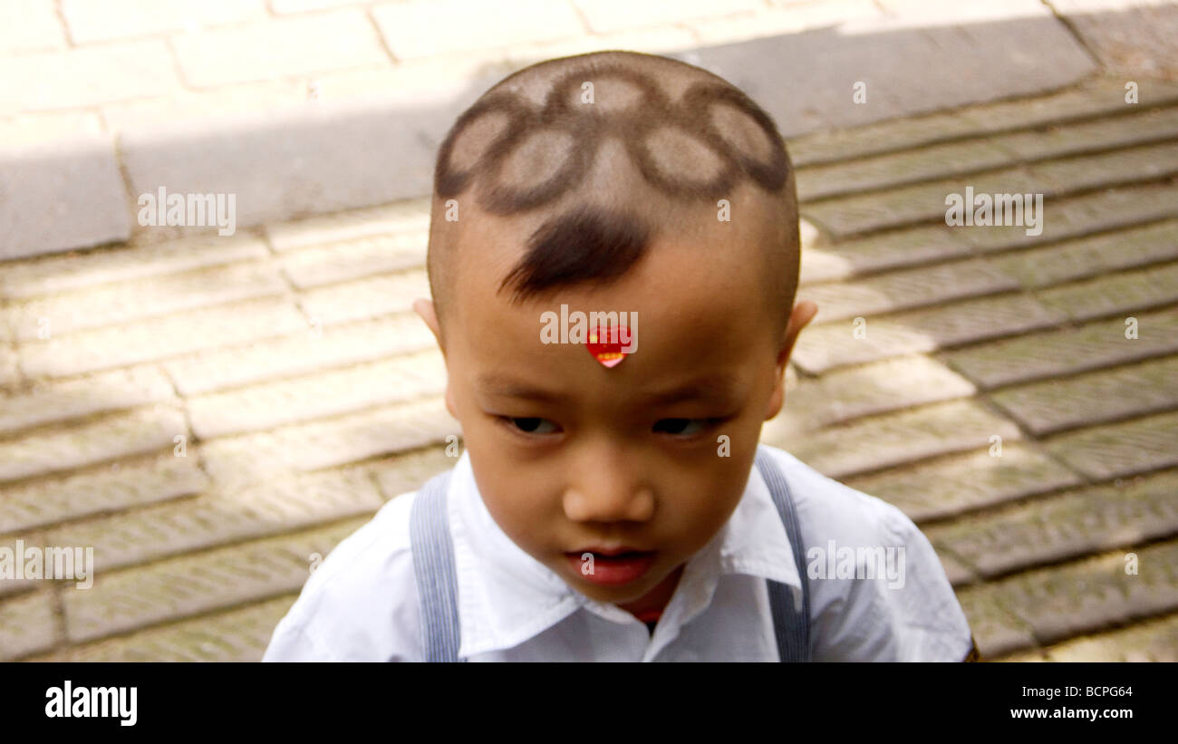 Chinese boy with Olympic logo hair cut, Beijing, China Stock Photo - Alamy