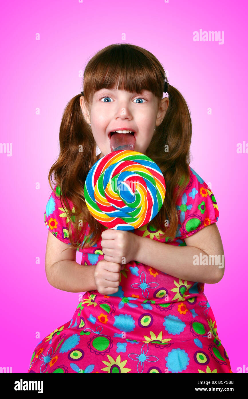 Portrait of a Funny Little Girl Licking a Lollipop Stock Photo Alamy
