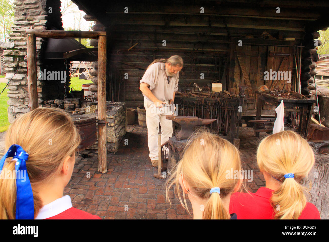 Children watch blacksmith at Fort Boonesborough State Park Richmond Kentucky Stock Photo