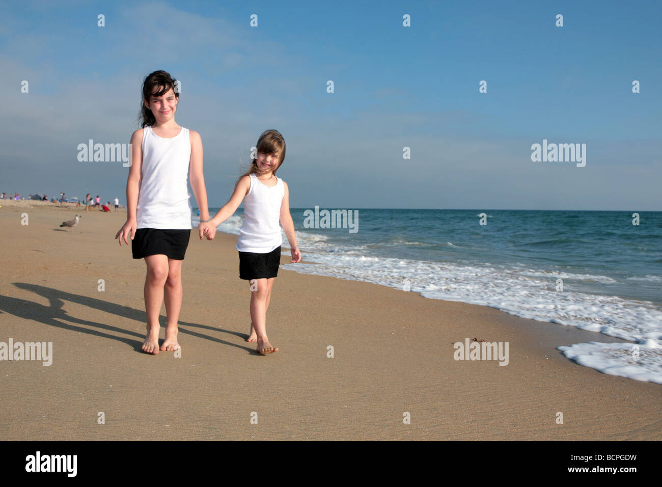 Happy Family of Sisters Holding Hands Walking Across the Beach Stock ...