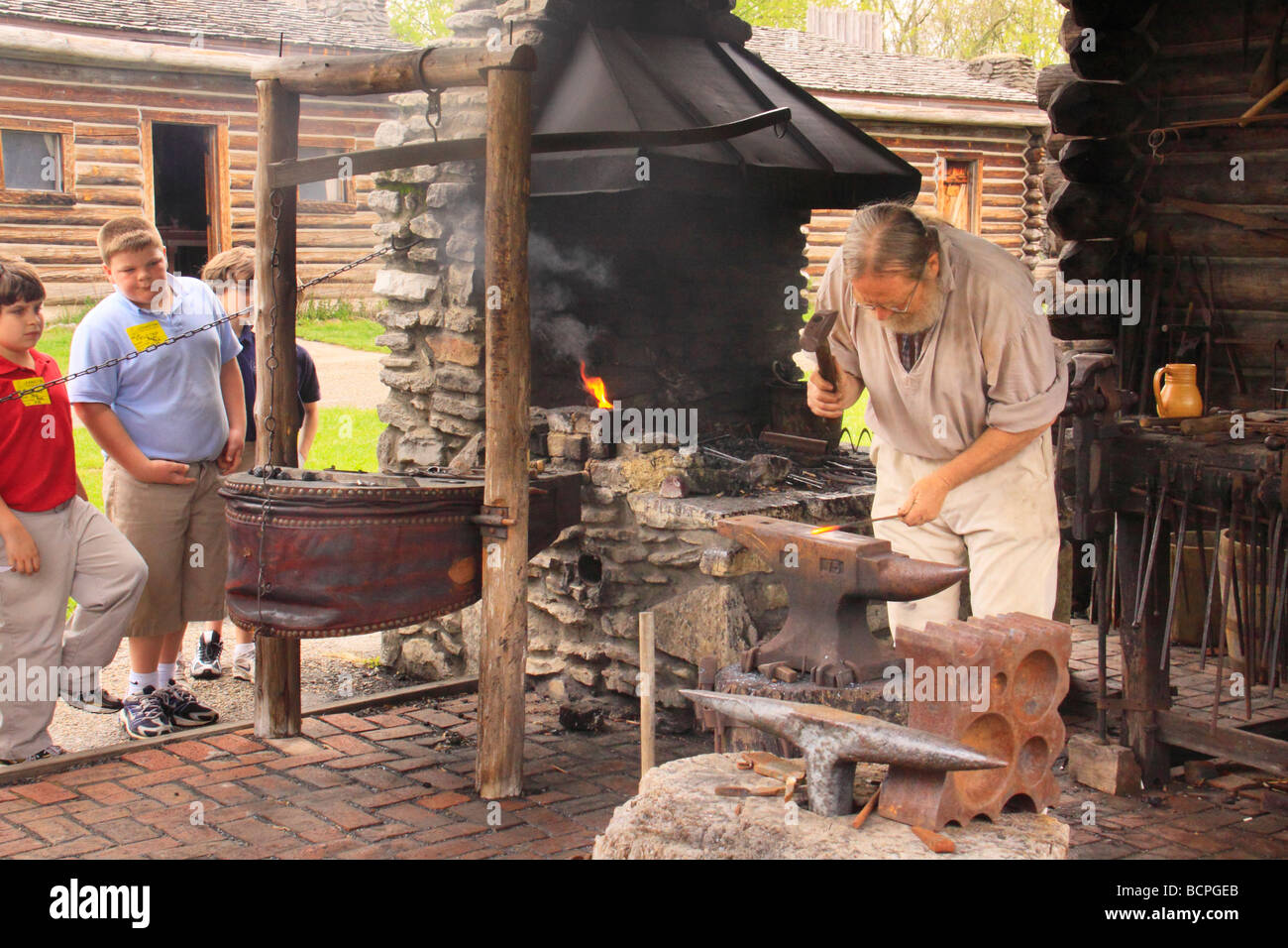 Children watch blacksmith at Fort Boonesborough State Park Richmond Kentucky Stock Photo