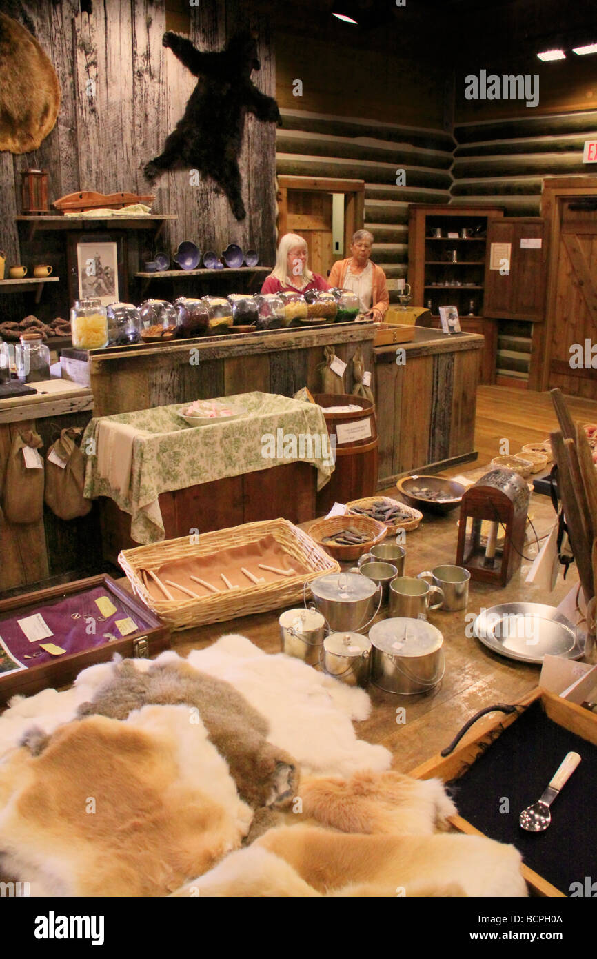 Costumed clerks behind counter of settlement store at Fort