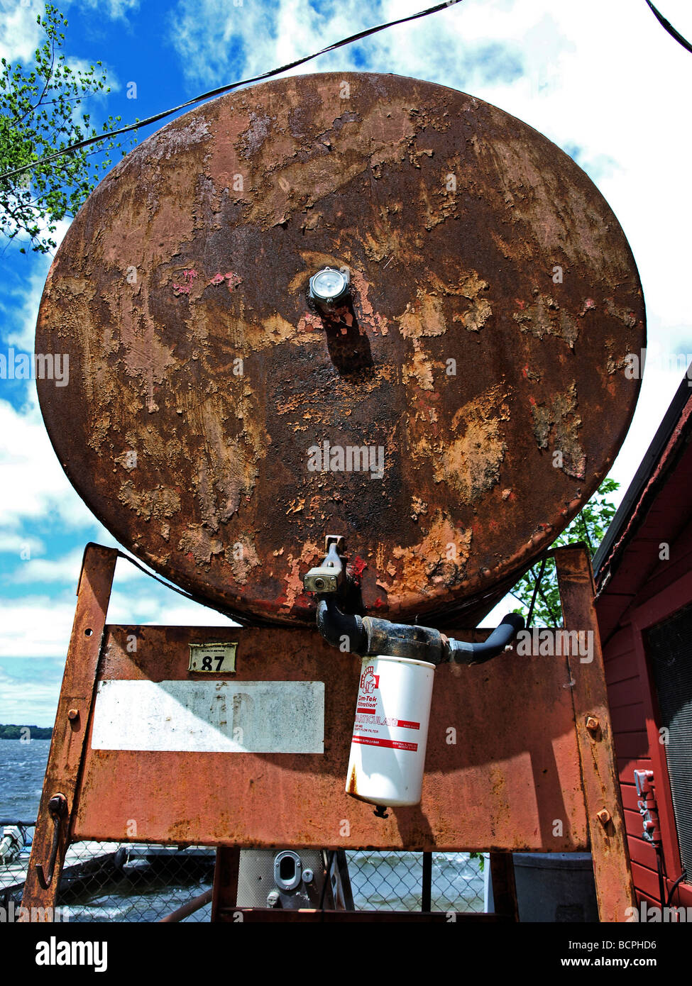 gasoline gas tank with filter on a stand with rust rusted Stock Photo