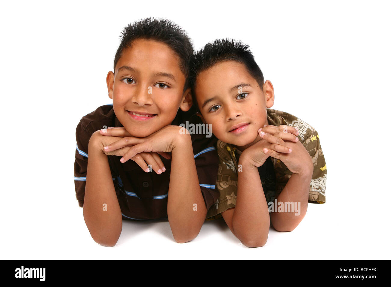Two Hispanic Young Brothers Smiling on White Background Stock Photo
