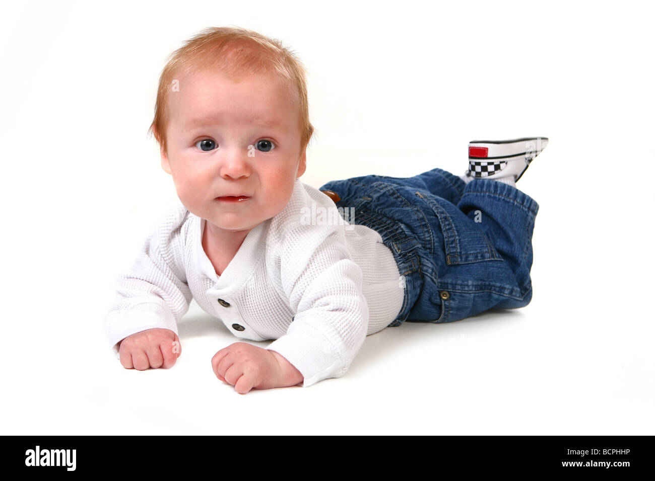 Surprised Baby Boy on His Tummy Wearing Jeans Stock Photo Alamy